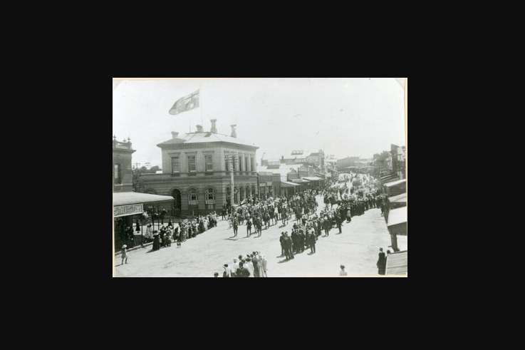 A street procession celebrates the end of WWI in front of the post office in 1918. Photo: AUSTRALIA POST