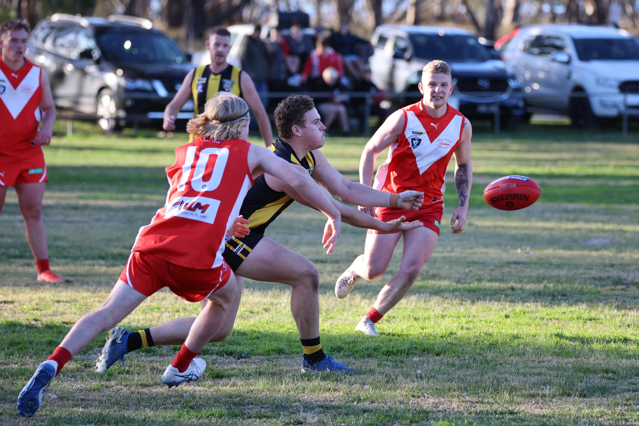 Pimpinio's Brock Hamerston fires out a handball while under pressure from Taylors Lake's Riley Hall and Connor Healy. Picture by RAELENE JOHNSTONE