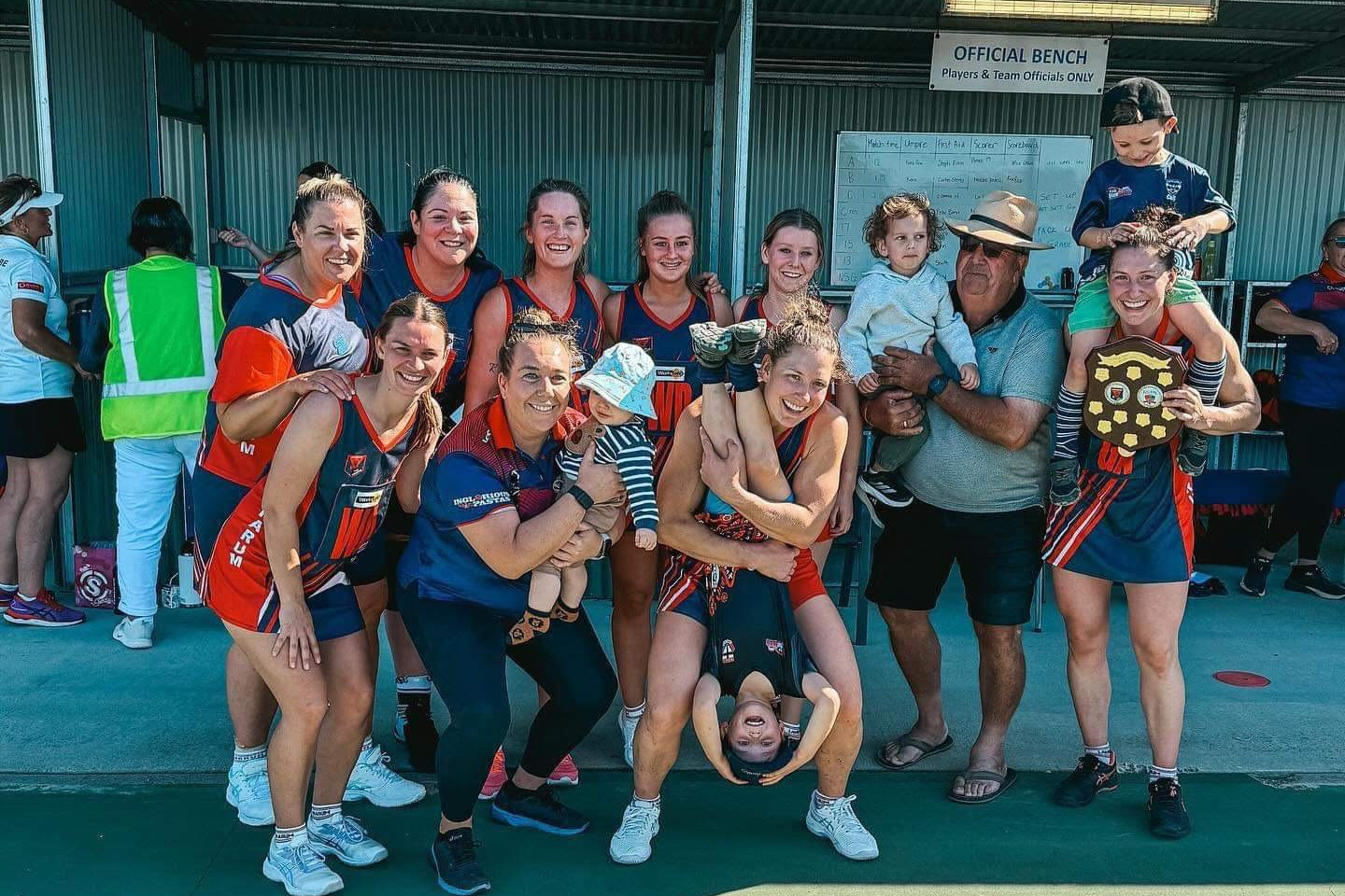 The Laharum netballers celebrate the victory in their annual Michele Mibus Memorial Round.