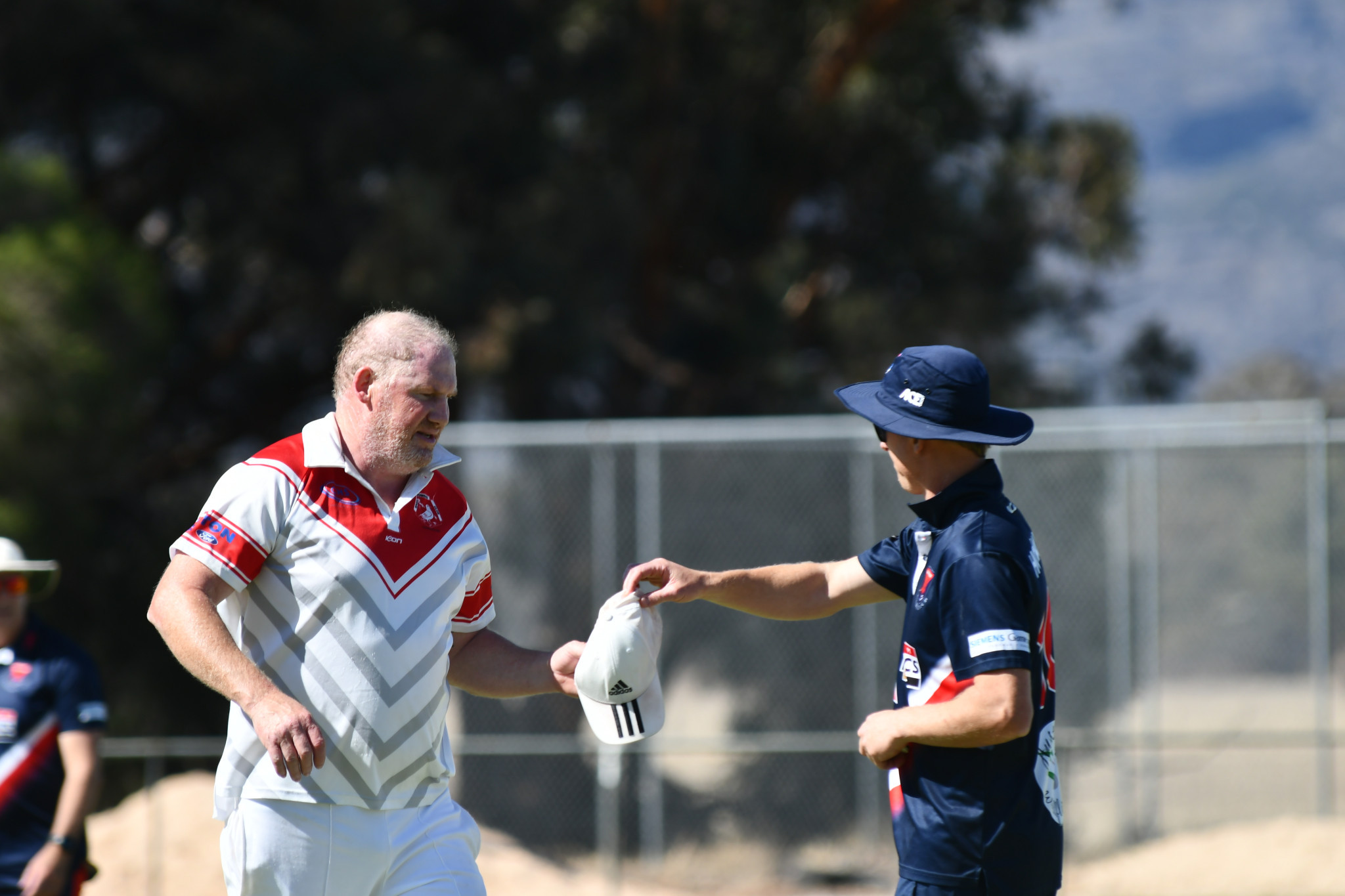 Homers’ opening bowler Terry Arnel takes his hat off the umpire at the end of the first over. PHOTO: CHRIS GRAETZ